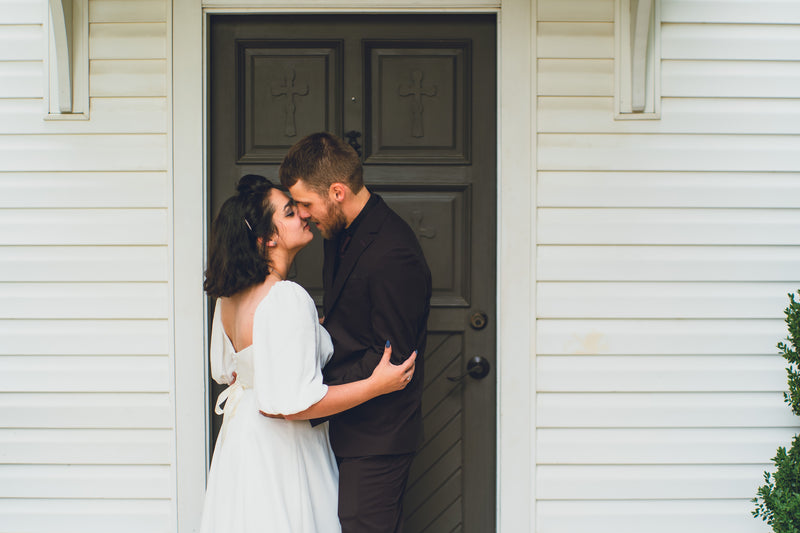 Newlyweds sharing a quiet moment outside their ceremony venue