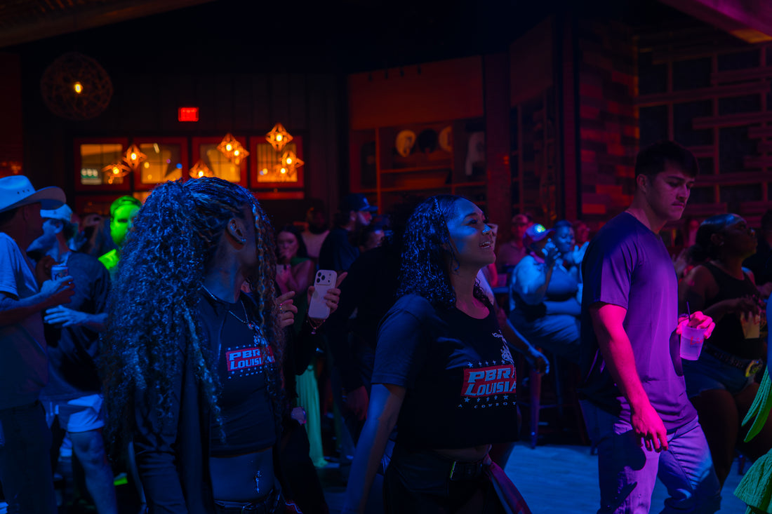 Guests on a lit dance floor at a private event